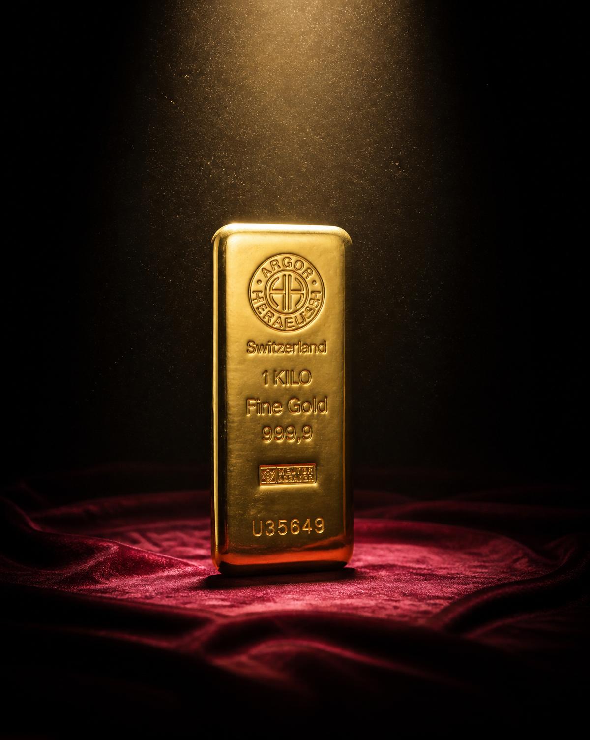 A single 1 kilo fine gold ingot standing on burgundy velvet, illuminated by a single warm spotlight.